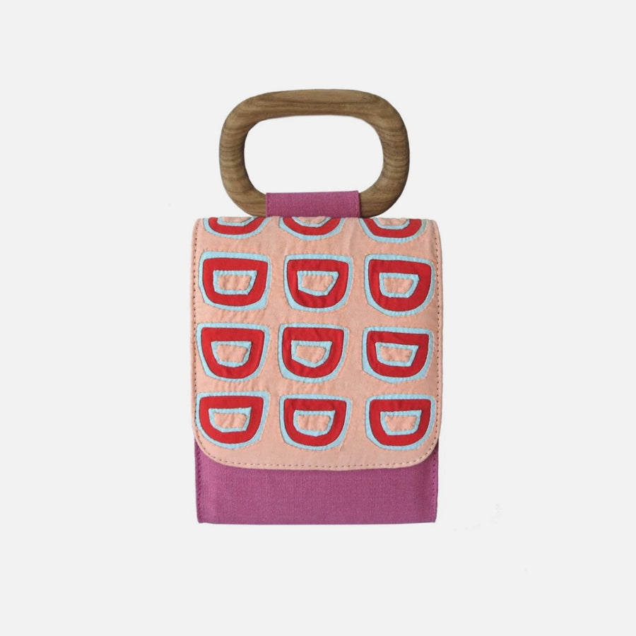 Based in Colombia, Yasmin Sabet’s Mola Sasa collaborates directly with indigenous communities in Colombia to translate traditional art and craft into contemporary accessories and home design collections.   Material: Cotton Poplin, Canvas, Wood Handle, Leather Strap Color: Peach, Mandarine, Light Blue, Fucsia, Blue