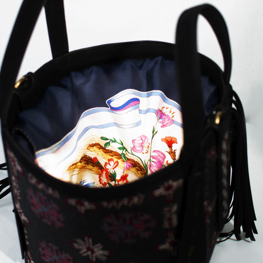 Demetria has created a limited collection of 50 handbags, which are unique pieces. Adorned with exceptional work from the T’boli, Mangyan and Tausug people, who hail from the southernmost edge of the Philippines, each piece is a complete expression of two different creative paths, European luxury and exceptional traditional skill.  A classic shape made out of embroidered calfskin with detachable shoulder and cross-body straps. The bag comes with a silk vintage scarf. 