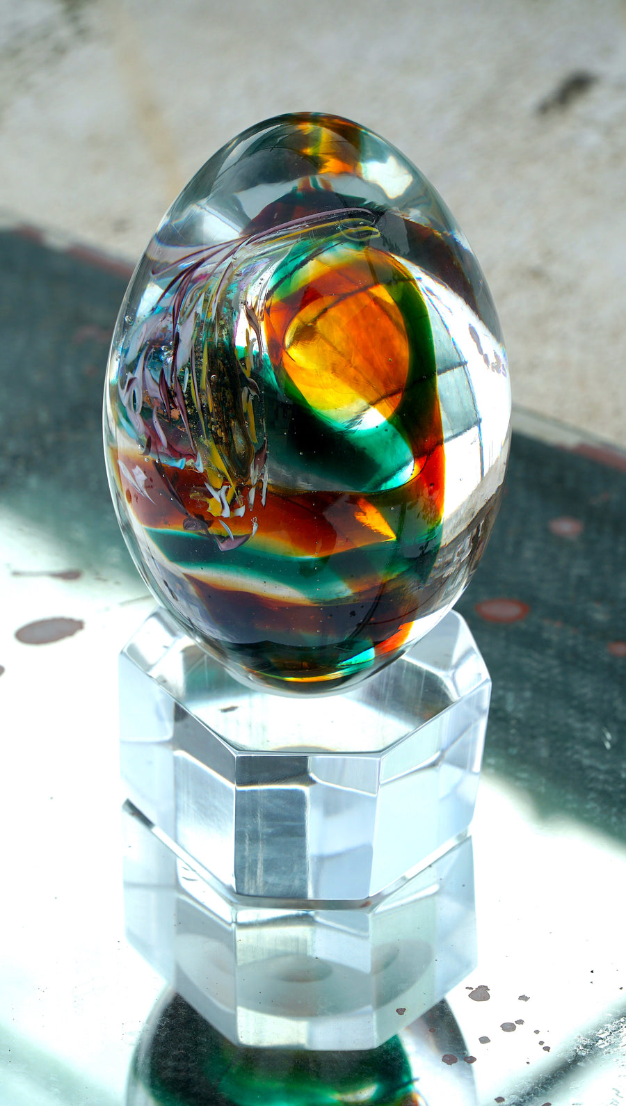 The Glass Egg is a hand sculpted unique piece with Murano Glass using the “Perle Sommerso” technique, which consists of submerging colored beads to create a multi layered effect.The work that Muriel does is considered part of "The Art of Venetian Glass Beads", a practice that comes under the Immaterial Heritage classification granted by UNESCO in January 2021.
