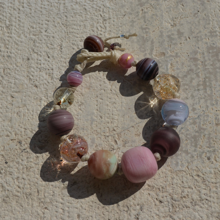 Muriel and her work are considered part of "The Art of Venetian Glass Beads", a practice that comes under the Immaterial Heritage classification granted by UNESCO in January 2021.  Purple Bracelet is an hand-made unique piece with Murano glass beads using the “Perle Sommerso” technique, which consists of submerging colored beads to create a multi layered effect.