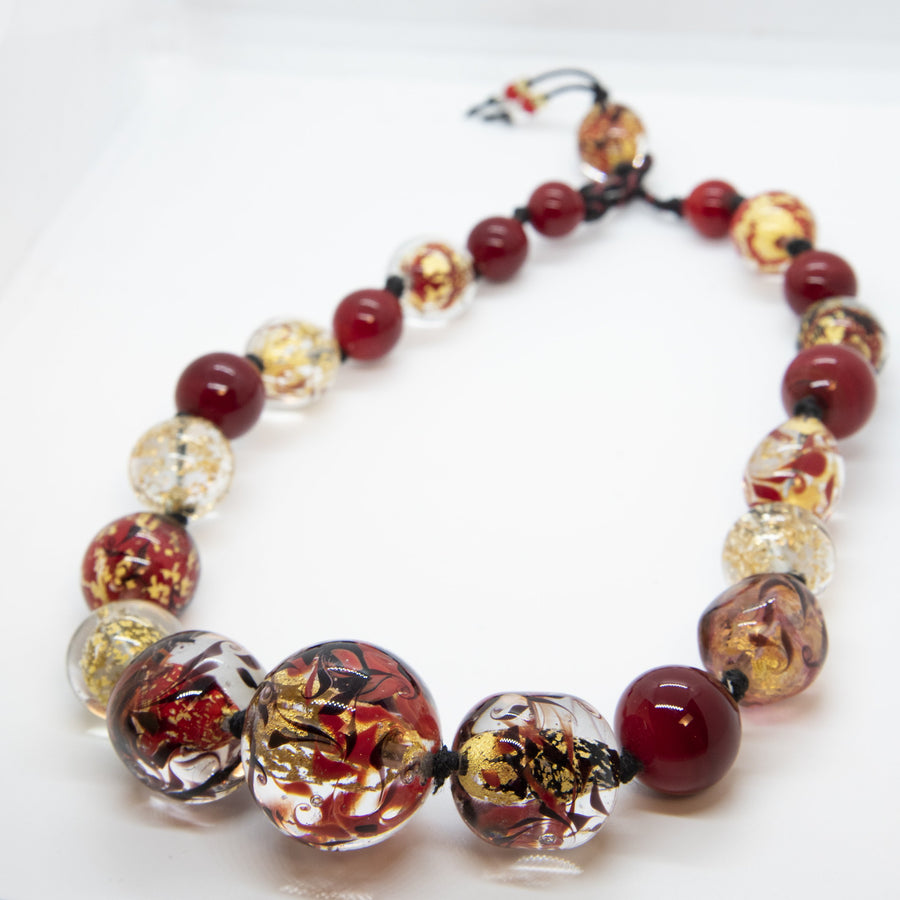 Muriel and her work are considered part of "The Art of Venetian Glass Beads", a practice that comes under the Immaterial Heritage classification granted by UNESCO in January 2021.  Purple Bracelet is an hand-made unique piece with Murano glass beads using the “Perle Sommerso” technique, which consists of submerging colored beads to create a multi layered effect.